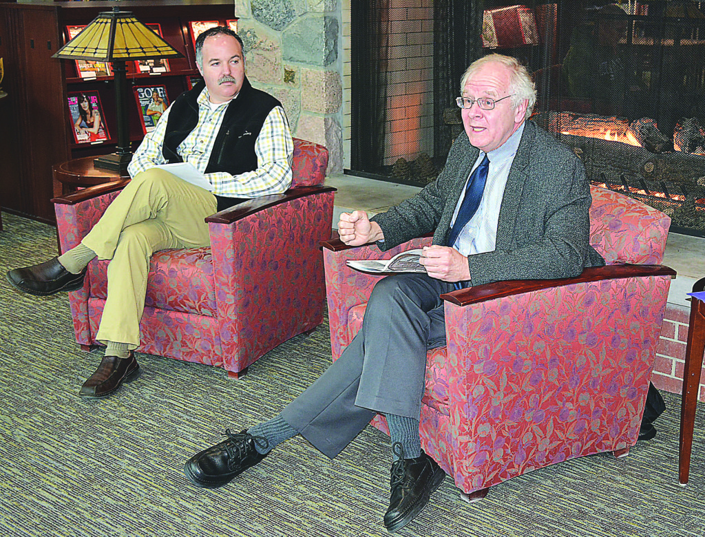 Frank Boles (right), director of the Clarke Historical Library, discussed the history of Michigan newspapers with Oxford Public Library Director Bryan Cloutier during a Jan. 13 fireside chat. Photo by CJC.