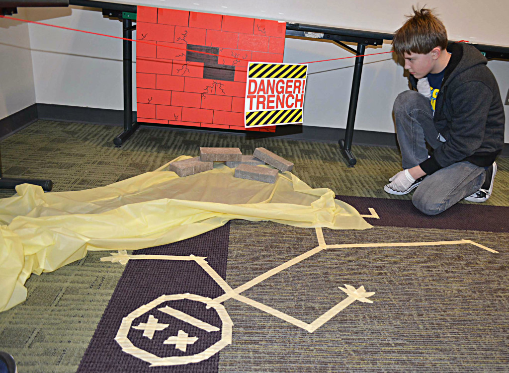 Oxford Middle School sixth-grader Gabe Mansfield examines the scene where the body was found.