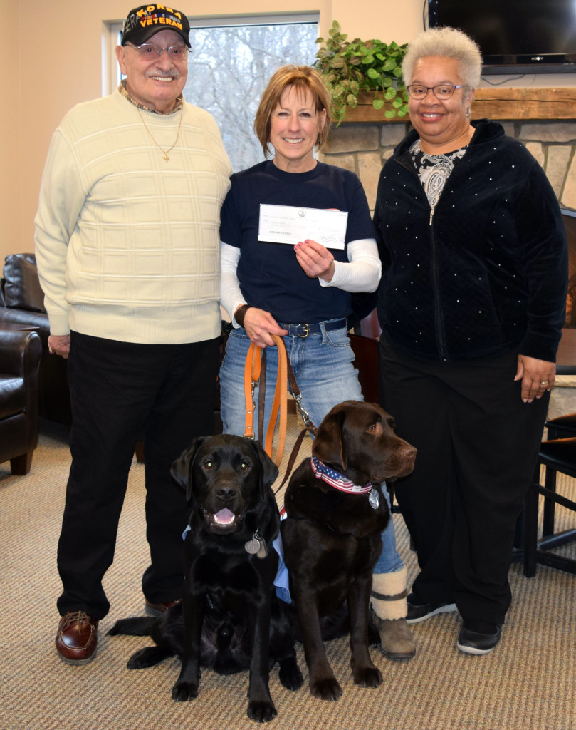 Kim Prud’homme (center), who owns Dogs of Honor, received a $2,000 donation from the now-closed Lakeville United Methodist Church. The check was presented last week at the Addison Township Hall by Geno Mallia, Sr. (left) and Pastor Jacque Hodges. Photo by Elise Shire.