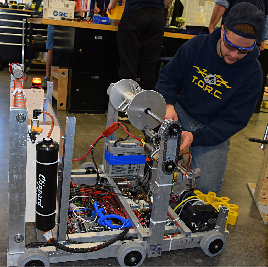 TORC 2137 Mentor Dante Zuccaro makes some adjustments to the team’s practice robot.