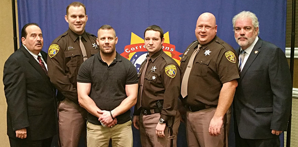 Flanked by Corrections USA Chairman James Baiardia (far left) and Treasurer Todd Dunn (far right) are Oakland County Sheriff’s deputies Daniel Drwencke, Steven Pryde, Brandon Hall and Chad Acheson. Photo provided.