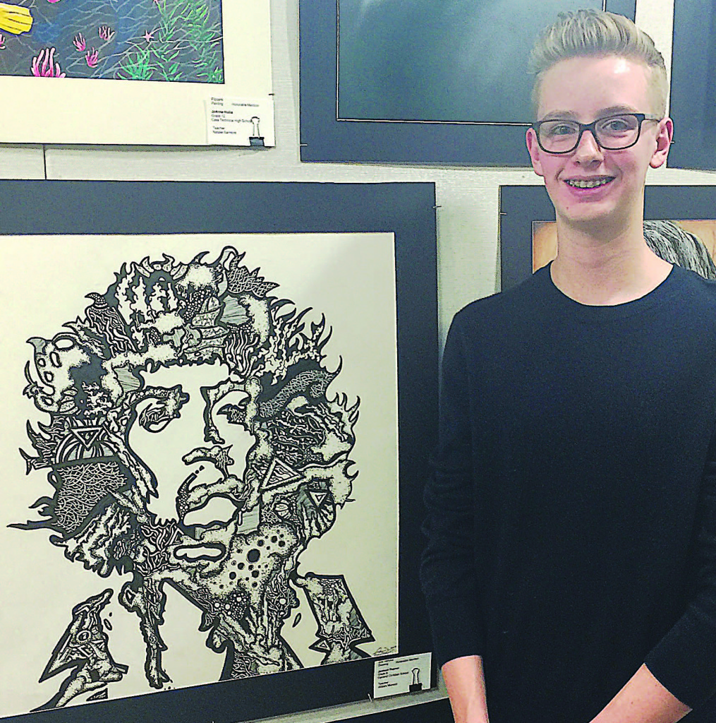 Artist Jackson Dupree, 14, of Oxford, poses with the ink drawing he created depicting legendary 1960s rock musician Jimi Hendrix. The piece won an honorable mention at the 2017 Southeastern Michigan Region of the Scholastic Art Awards. Photo provided.