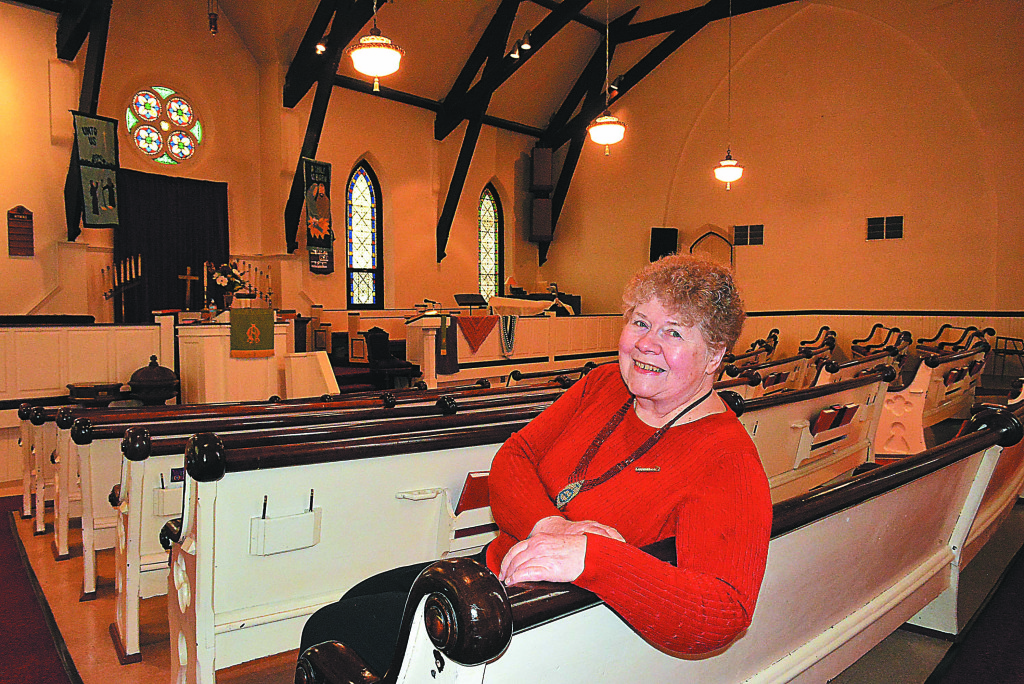 Rev. Liz Wilson, pastor of Immanuel Congregational United Church of Christ, is inviting the public to attend a special service celebrating the church’s 140th anniversary on Sunday, Feb. 26 at 11 a.m. She’s pictured here inside the church’s sanctuary. Photo by CJC.