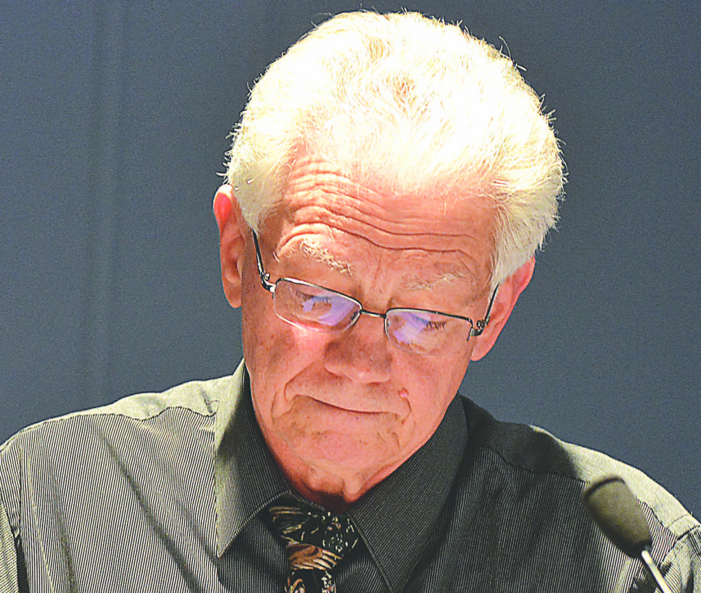 Oxford Village Manager Joe Young looks down as the motion is made to terminate his employment as of March 31.