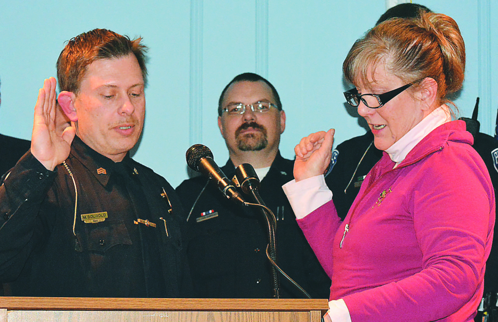 Mike Solwold (left) gets sworn-in as interim/acting chief of the Oxford Village Police Department by village Clerk Susan Nassar. Photo by C.J. Carnacchio.