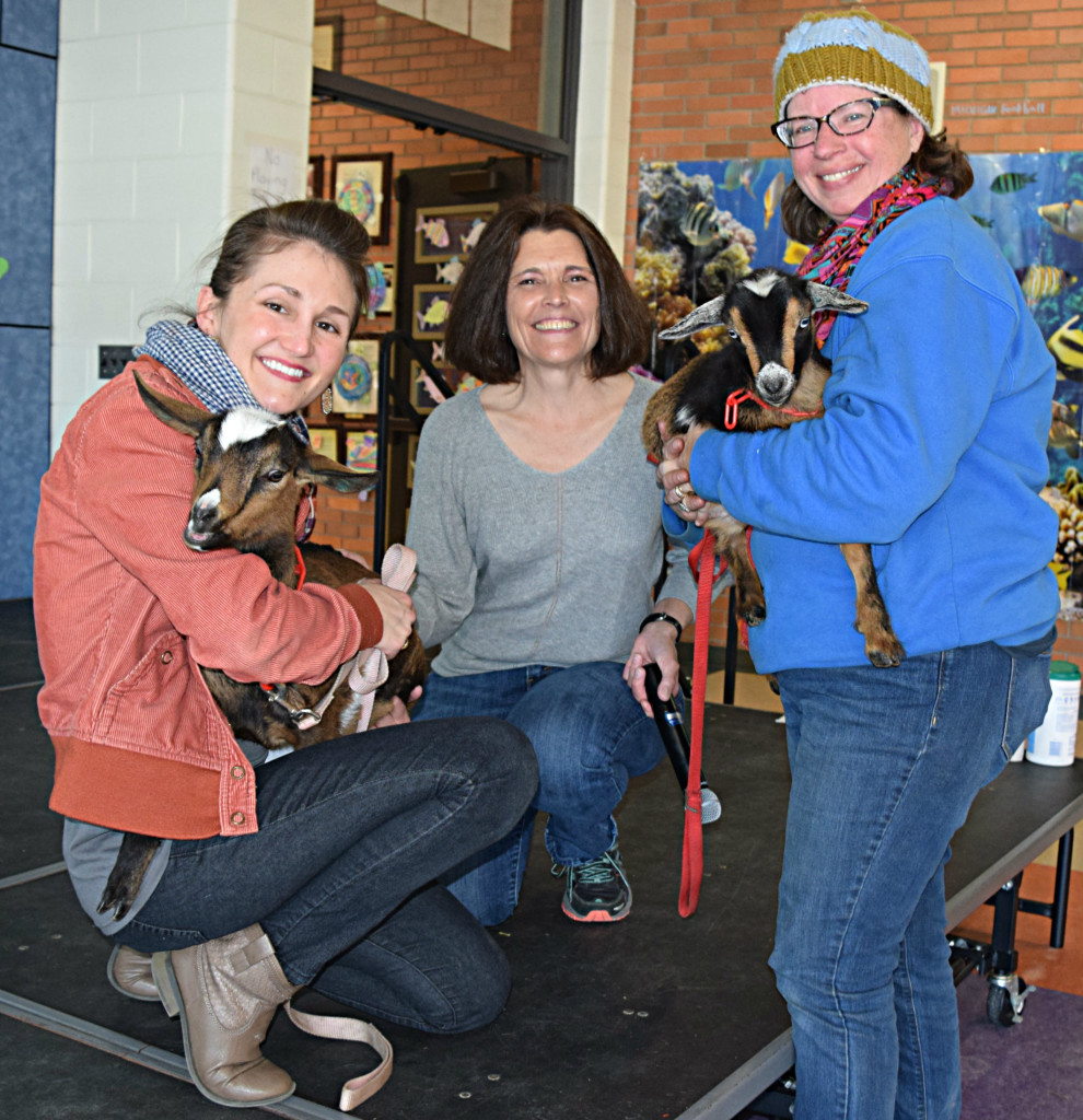 IB Coordinator Rita Flynn (left) and Amy McIntire (right), co-owner of City Girls Farm hold a couple of adorable baby goats. Between them is Polly Ann Trail Mgr. Linda Moran. Goats will be used on the trail to help eliminate invasive plants. Photo by Elise Shire.