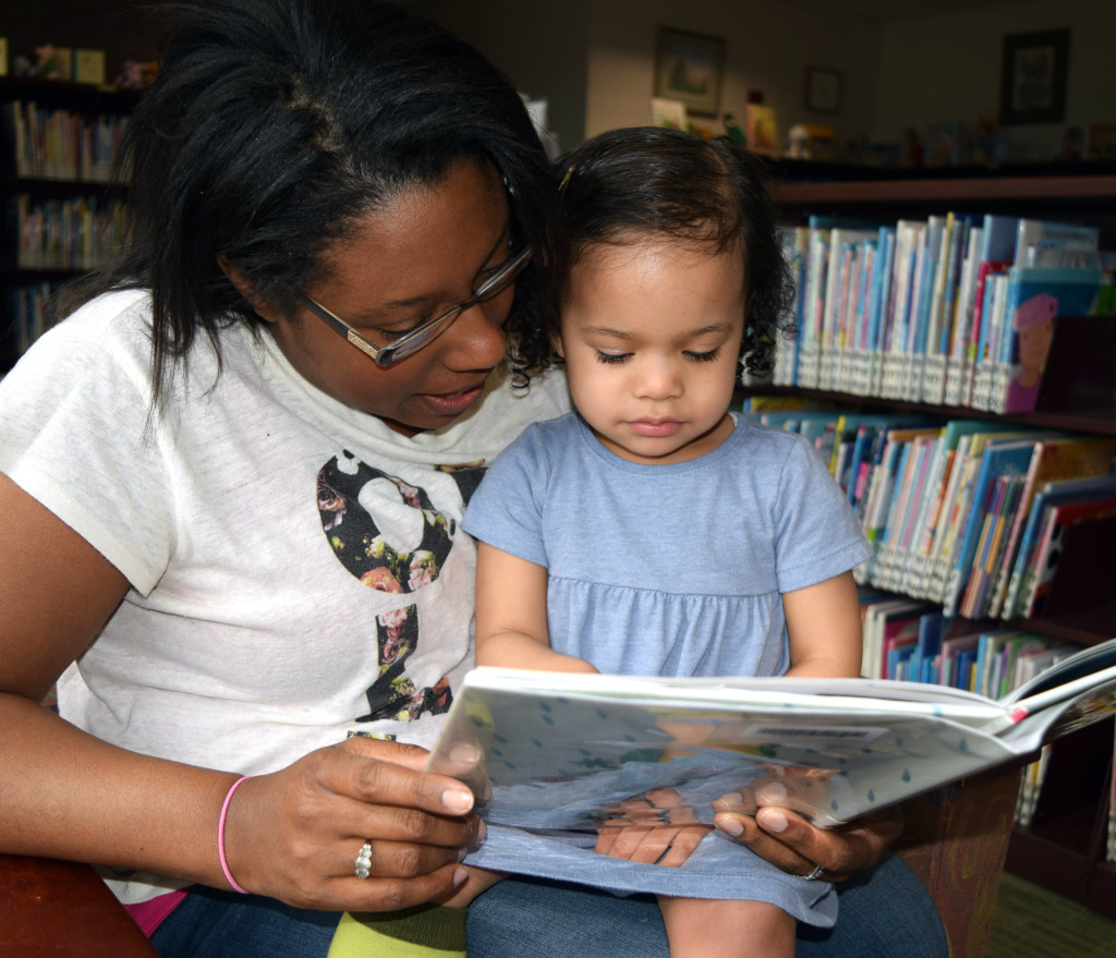 Oxford resident Brandie Pahl reads “Rain!” to her 2-year-old daughter, Cecilia, at the Oxford Public Library. Photo by Elise Shire.