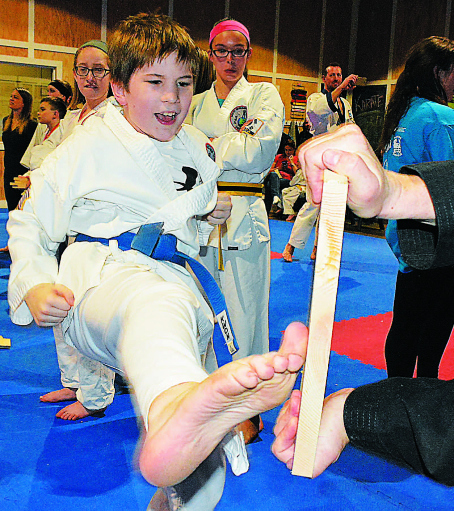  Oxford Elementary fifth-grader Dylan Przepiora, a student with North Oakland Taekwon-Do, kicks a board.