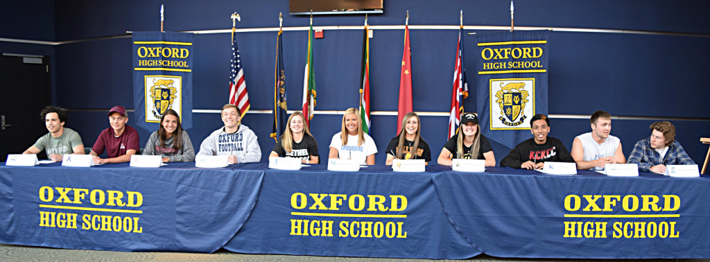 Last week, 11 Oxford High School seniors signed letters of intent to play their respective sports at the college level. Pictured are (from left) Ethan Williams, Lucas Sereno, Katie Romano, Drake Barry, Sophia Bell, Mackenzie Chaisson, Madison Dinges, Emma Gordon, Jordan Jaden, Ryan Motala and Spencer Petosky. Adam Bell did not attend the signing ceremony. Photo by Elise Shire.