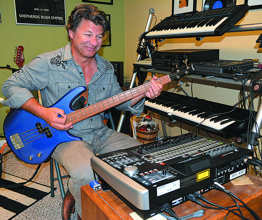 Oxford musician Michael Young plays around in his private studio. His new album is “One by One.” Photo by CJC.
