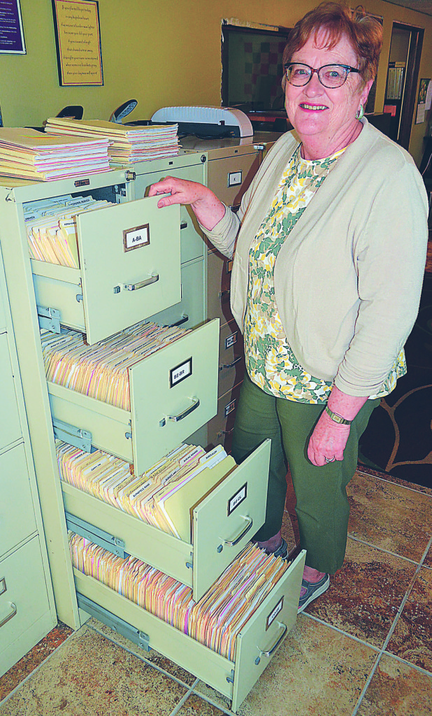 Sandy Weaver, executive director of Love INC of North Oakland County, has file cabinets packed with records chronicling all the individuals and families the organization has helped since opening its doors in 2007. Photo by C.J. Carnacchio.