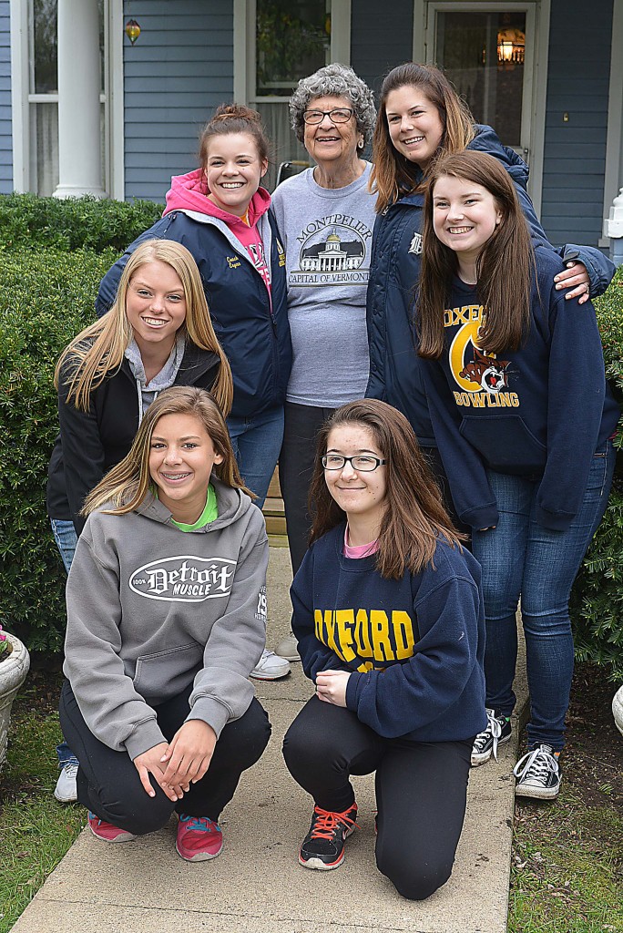 Oxford Village resident Shirley Conner (standing in the center) poses with the young women who beautified her yard. Standing on either side of Conner are OHS cheerleading coaches Erynn Pauli (left) and Christie Desano. With them are OHS cheerleaders (clockwise from right) Erin Dinan, Faith Knop, Gabi Stublensky and Sarah Liford. Photo by C.J. Carnacchio.