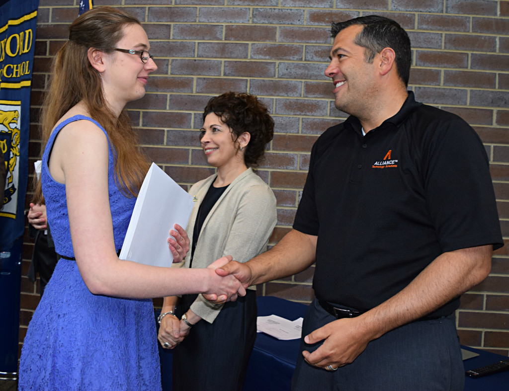 Acacia Krofenberg, a graduate of Oxford Schools Early College Program, is congratulated by Oxford Board of Education President Dan D’Alessandro. Photo by Elise Shire.