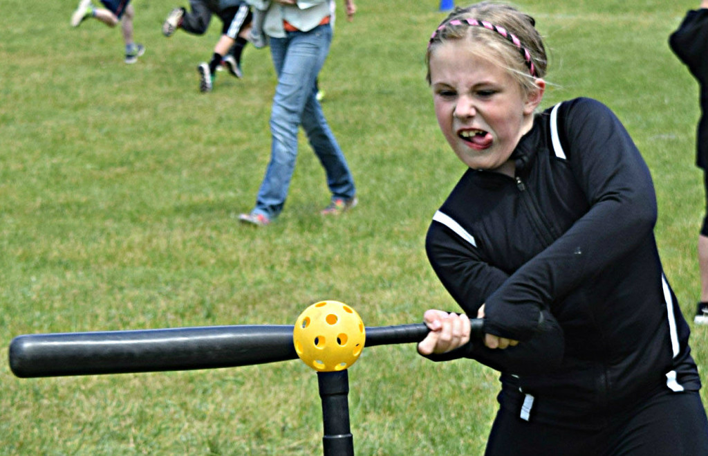 Sydney Dunfee, a third-grader, is up to bat and has a look of sheer determination!