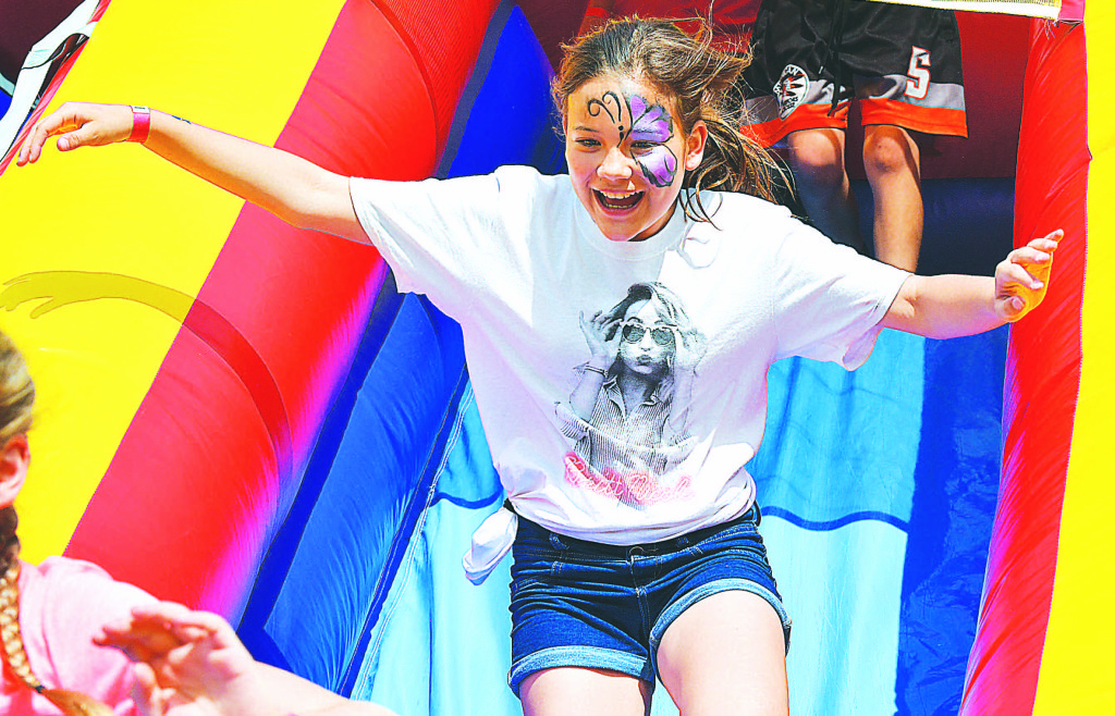 Kingsbury fifth-grader Caitlyn Woods races down the slide. Photo by C.J. Carnacchio.