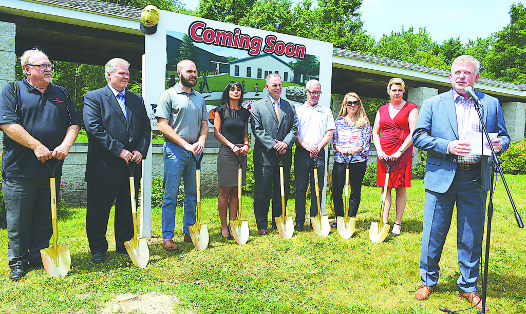 Mark Fleischer (far right), chairman of the Kingsbury Trust Board, speaks during the groundbreaking ceremony. Behind him are (from left) Howard Dibble, vice chairman of the Trust; outgoing Head of School Tom Mecsey; incoming Head of School David Poirier; Oxford Bank representatives Erica Monear and Mark Morrison; Andrew Donato, owner/president of the Clarkston-based Donato Group, Inc., general contractor for the expansion; Kim Prochko, president of the Kingsbury Parents Association; and Christine Stephens, president of the school’s board of directors. Photo by C.J. Carnacchio.