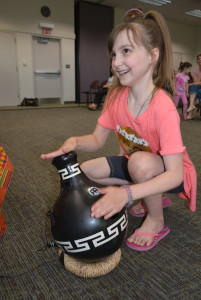 RIGHT: Oxford resident Madelyn Porter, 8, plays an udu, a unique drum from Nigeria. 