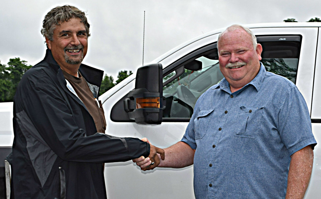 Kent Phillips (left), owner of Kent’s Lawn Care, shakes hand with Addison Supervisor Bruce Pearson. 