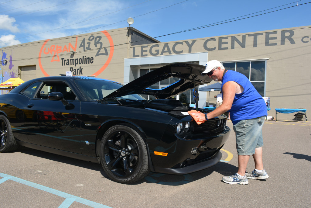 Wiping down his limited-edition Mopar 2014 Dodge Challenger  is Orion resident James Johnson. Only 100 were made that year.
