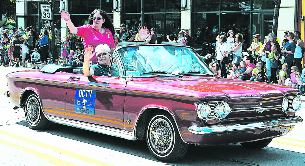 Connie Miller, host of “Connie’s Kitchen” on Oxford Community Television, waves to the crowd from the back of a 1964 Chevy Corvair. Riding in the front passenger seat is Oxford Township Trustee Elgin Nichols, who also works for OCTV. Driving is Dave Kenny.