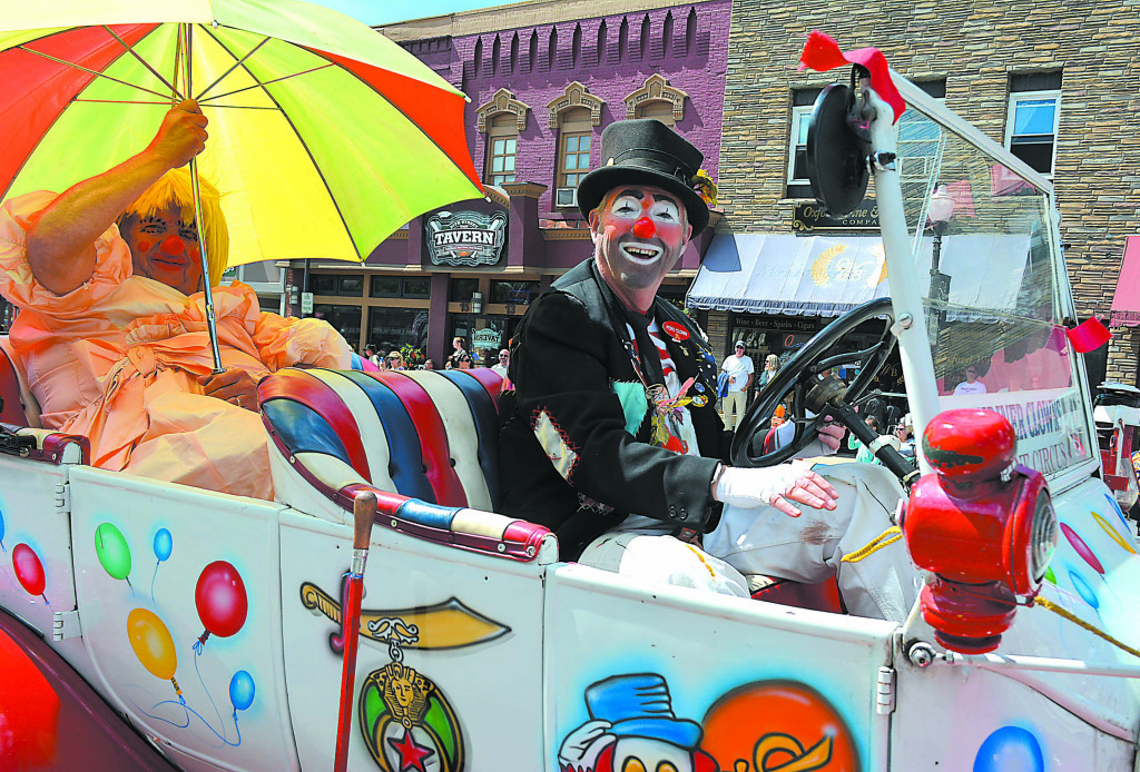 Shriner Clown Steve Gotham, of Hadley Township, was all smiles as he drove along M-24.