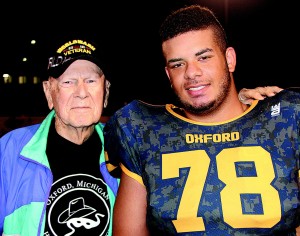 OHS player Jason Green wore a jersey bearing the name of WWII veteran Webster Gemmel (left), an Oxford resident who served in the U.S. Navy. Photos by C.J. Carnacchio.