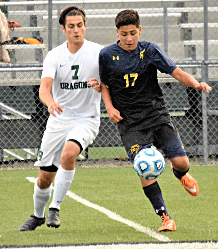 Oxford’s Chris Escalante (right) and Lake Orion’s Justin Fraser battle for the ball. 