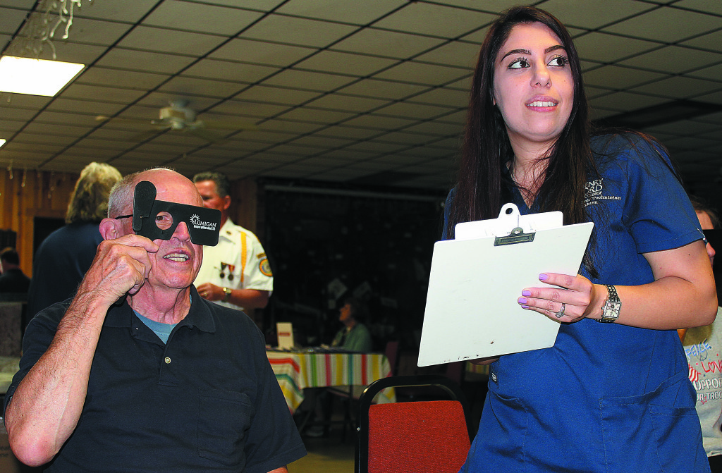 Metamora Township resident James Mott gets his vision checked by Racha Kaafarani, a second-year extern in the Henry Ford College Ophthalmic Technician Program.  Mott served in the U.S. Navy from 1957-61.  Photo by C.J. Carnacchio.