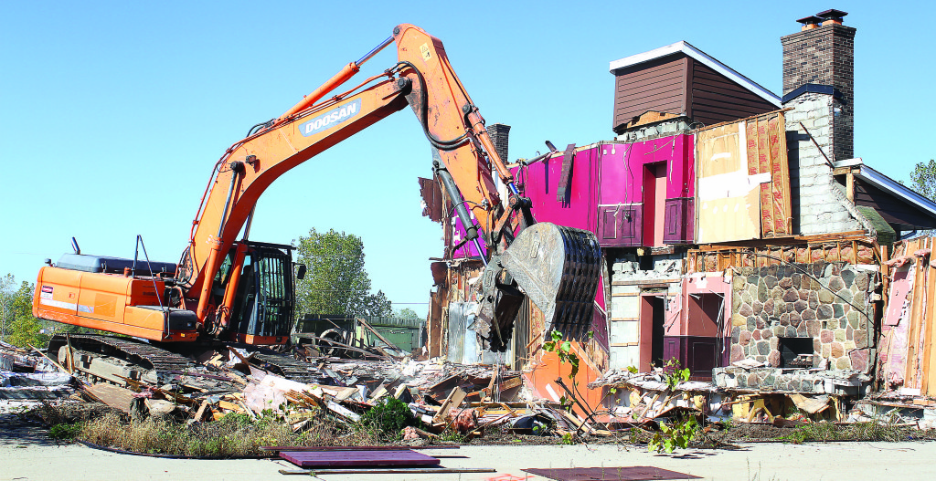 It didn’t take very long to reduce the former Burning Oak Smokehouse building to a heap of rubble. Photos by C.J. Carnacchio.