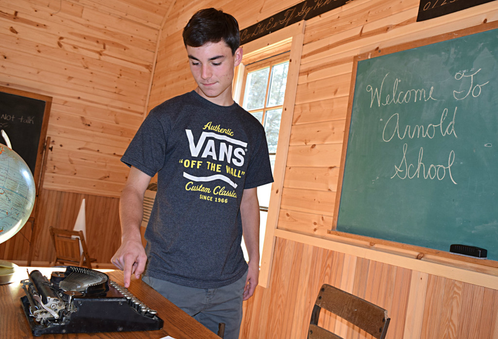 Addison Township resident Nick Morawski, 15, checks out an old-fashioned typewriter inside the Arnold Schoolhouse.  Photo by Elise Shire.