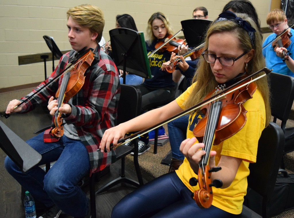 Oxford High orchestra students Ethan Pearson and Tabitha Sterner perform their parts on the violin. Photo by Elise Shire.