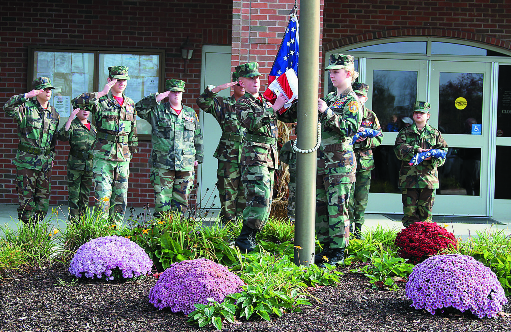 The North Oakland County Young Marines performed a flag-raising ceremony at the Oxford Township Hall. They presented flags to the families of Sue Bellairs and Dale Birch.  Photo by C.J. Carnacchio.