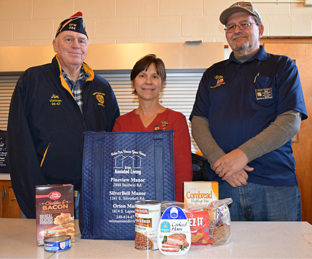 The North Oakland Veterans of Foreign Wars (VFW) Post 334 Commander Jim Hubbard (left) and VFW Post 334 Quartermaster Chuck Haskin delivered 28 bags filled to the brim with food for local seniors. Meals on Wheels volunteer Mary Reynolds (center) helped distribute them. Photo by Elise Shire.