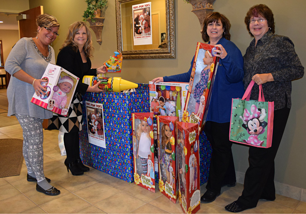 Real Estate One, located in Oxford, is accepting donations for Toys for Tots. Pictured are Cindy Arksey (left), Branch Mgr. Mary Matthews, Lisa Bunker and Judy Narducci. Photo by Elise Shire.