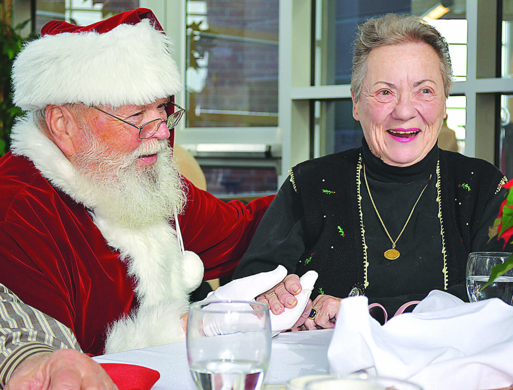Enjoying her time with Santa is Carole Greco, of Oxford. Photo by C.J. Carnacchio.