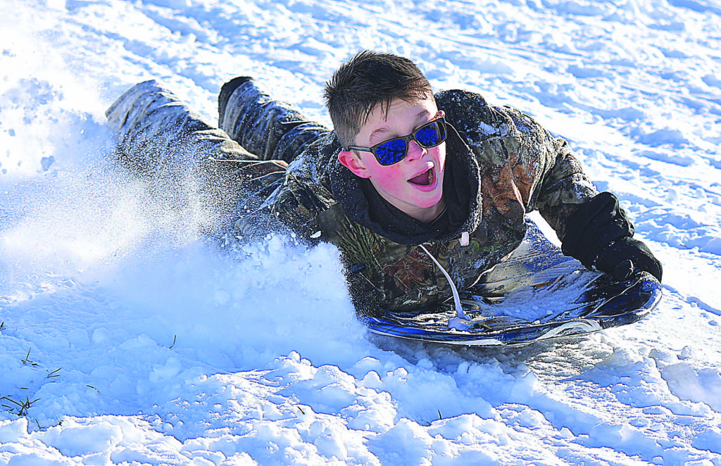 The Oxford area received its first big snowfall of the winter Dec. 13 when approximately 9 inches of the fluffy white stuff coated the ground. School was closed the next day and many kids and parents decided to enjoy their snow day playing outside. Some, like Hunter Hughes (above), a sixth-grader at Kingsbury Country Day School, went sledding at Seymour Lake Twp. Park. For more snow day photos, please puchase a copy of The Oxford Leader. Photo by C.J. Carnacchio.