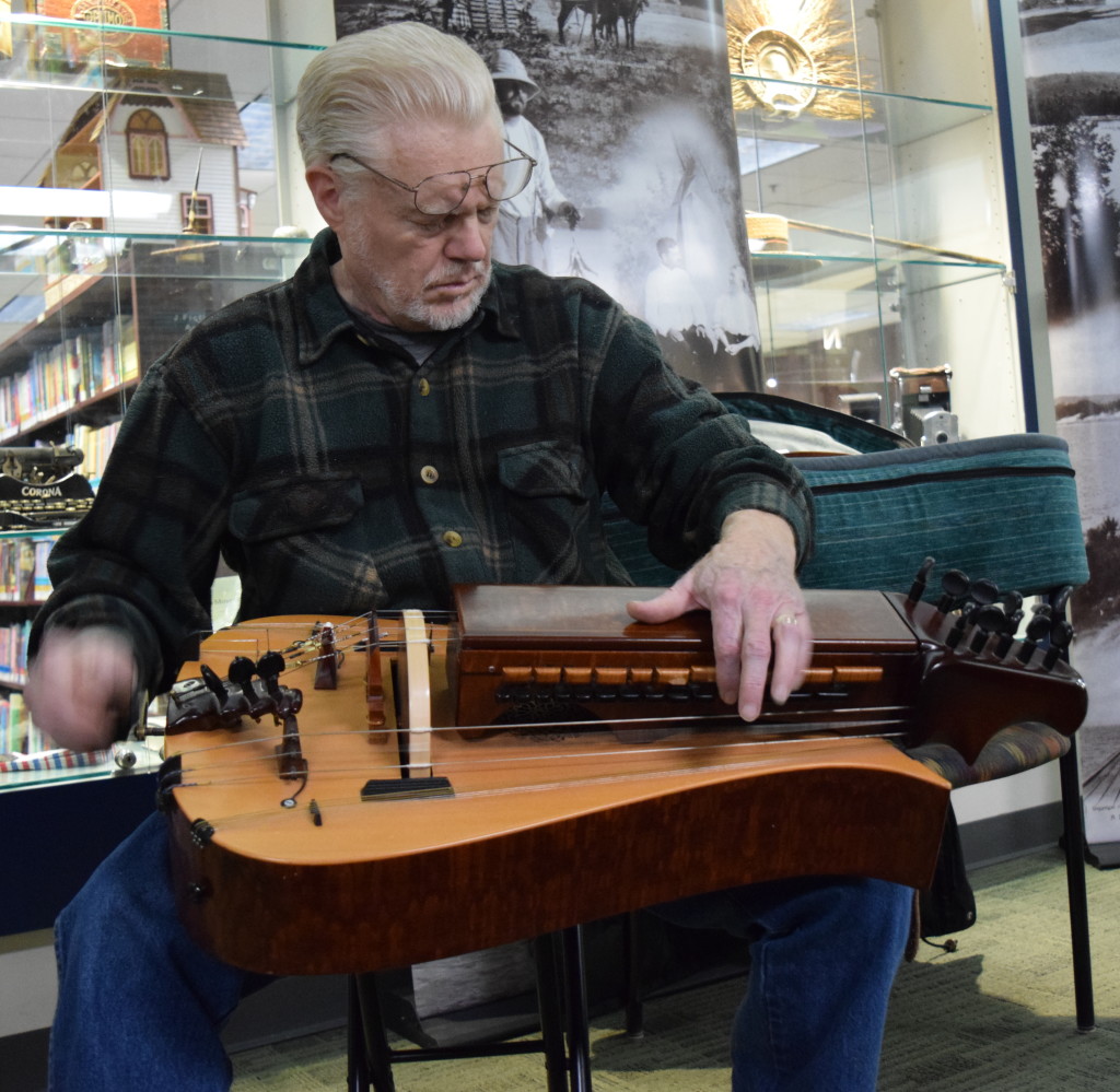 Ned Dorries entertains folks at the Oxford Public Library with his  hurdy-gurdy stylings.  Photo by Elise Shire.