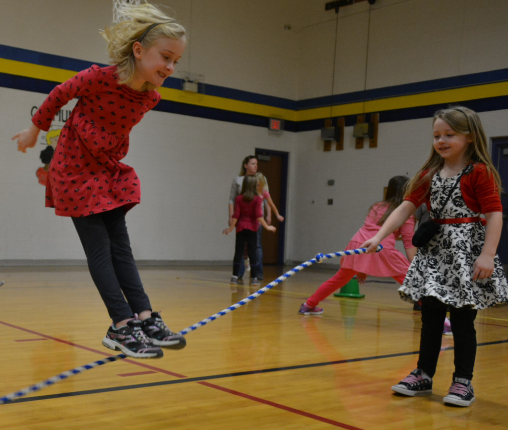 Lakeville second-grader Elizabeth Powers (left) jumps while Madison Jenkins works the rope.