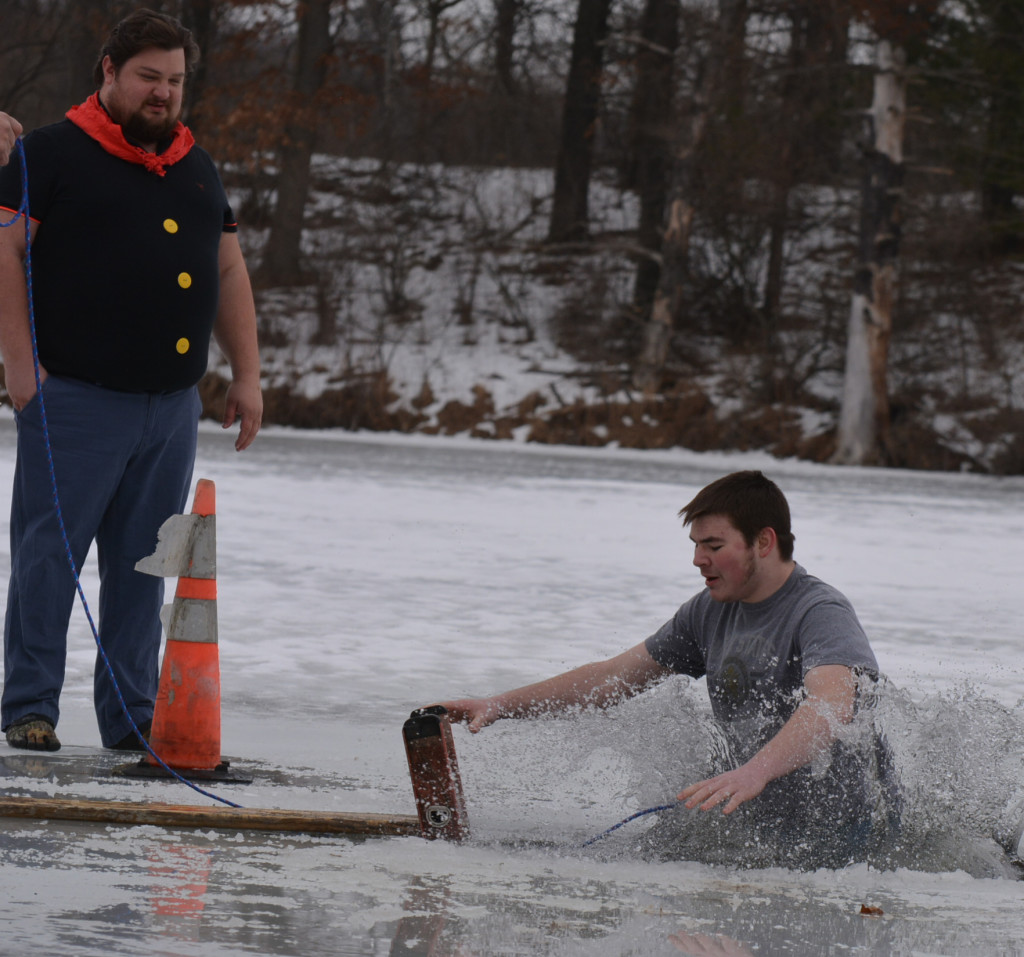 Lucas Bivens (right) plunged into the icy waters of Addison Township’s Shadow Lake on Saturday. Watching and waiting for his turn is Jason Judkins, of Leonard. Photo by C.J. Carnacchio.
