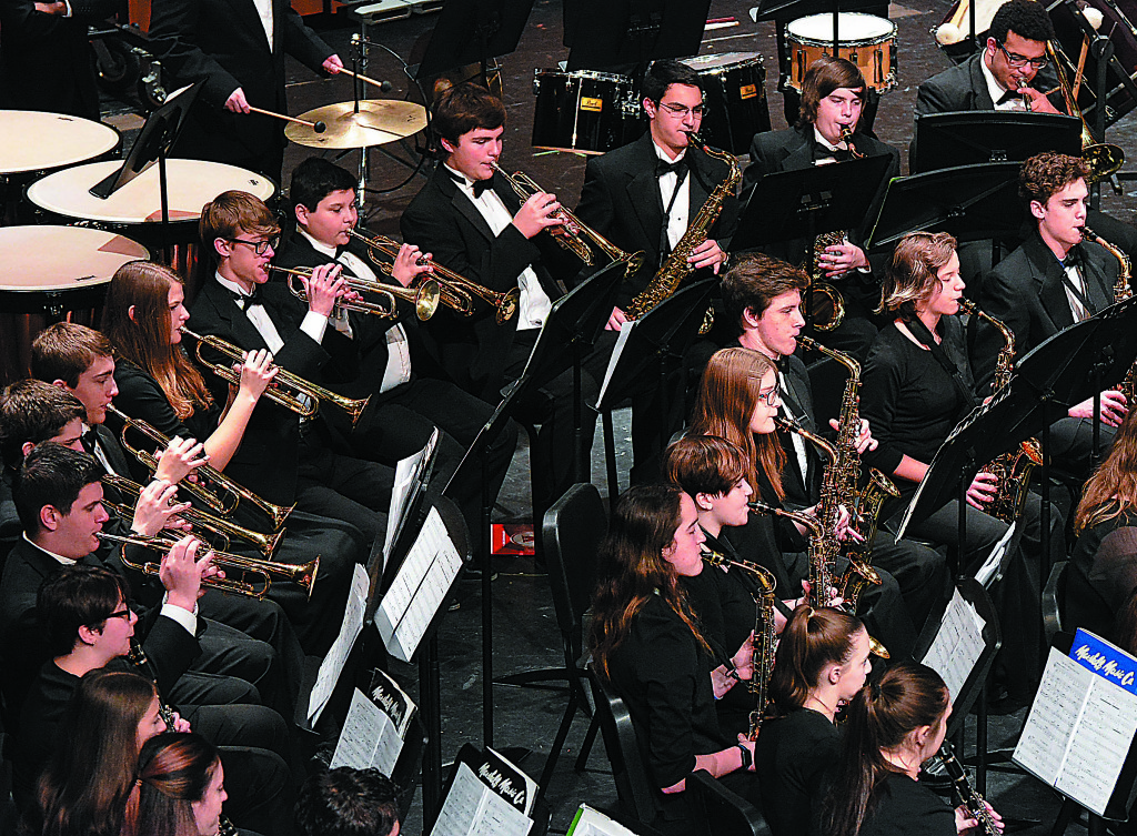 Oxford High School’s Symphonic Band, conducted by Jim Gibbons, performs during the Michigan School Band and Orchestra Association’s District 3 Festival held Friday and Saturday at the OHS Performing Arts Center. The band received straight 1’s (the highest score possible) from the judges. Photo by C.J. Carnacchio.