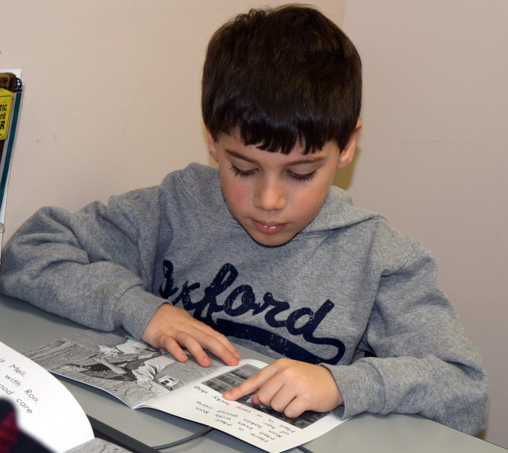 Daniel Axford first-grader Kasen Cribbens practices his reading. Photo by Elise Shire.