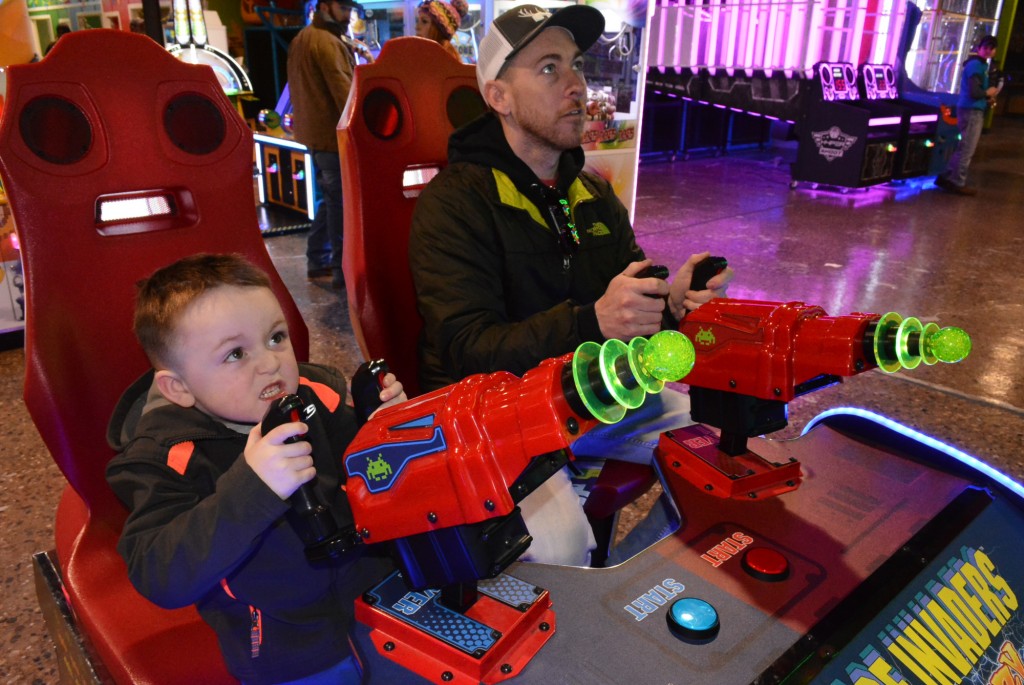 Oxford resident Bobby Roop enjoys playing a super-sized version of the classic video game Space Invaders with his son Emery, 4. That is quite the intense look on little Emery’s face.
