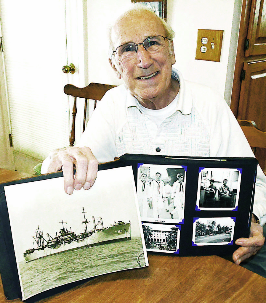 WWII veteran Steven Maczko, of Oxford, with photos from his days in the U.S. Navy. Photo by CJC.