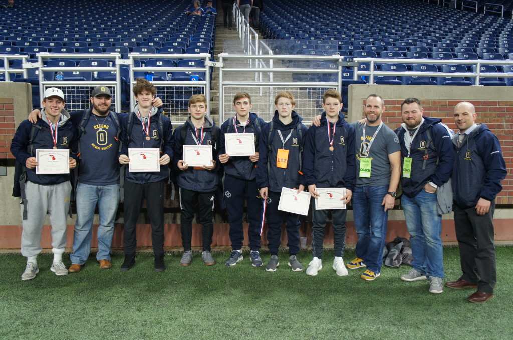 Wildcat grapplers who competed at the MHSAA Individual State Finals last Saturday included Trent Myre (from left), Ryan Miller, Sergio Borg, Liam Hillary, Ashton Anderson and Matthew Curtis. Joining them are Coach Ross Wingert, Coach Brandon Rank, Coach Alan Wilfong and Coach Craig Trombly. Photo provided.