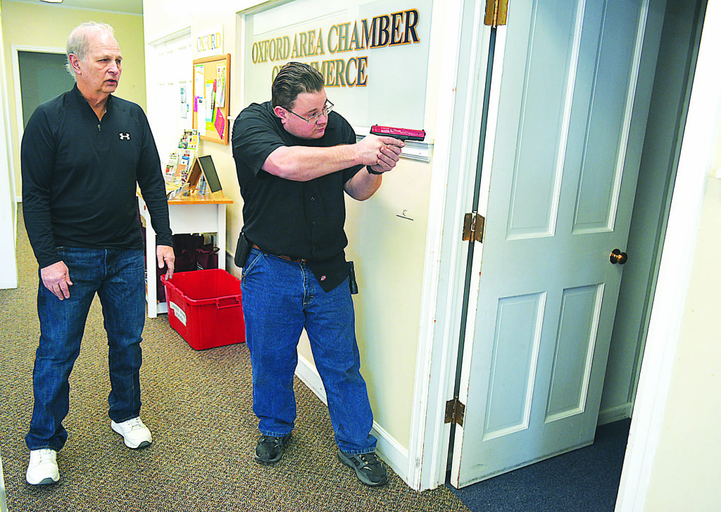 Oxford Village Reserve Police Officer Jacob Wainz (right) conducts a room-by-room search at the W. Burdick St. municipal complex as part of active shooter threat training. Overseeing his training is Reserve Officer Gene Faermark. Photo by C.J. Carnacchio.