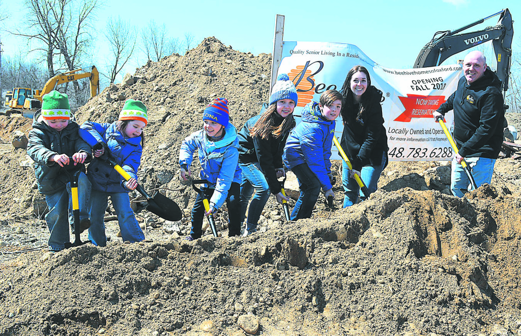 Participating in the ceremonial ground-breaking for the new BeeHive Homes facility in Oxford Village is the Kopmeyer family. Pictured (from left) are Henry, Gretchen, Bridget, Caroline, Gordon and owners/operators Marie and Matt. Photo by C.J. Carnacchio.