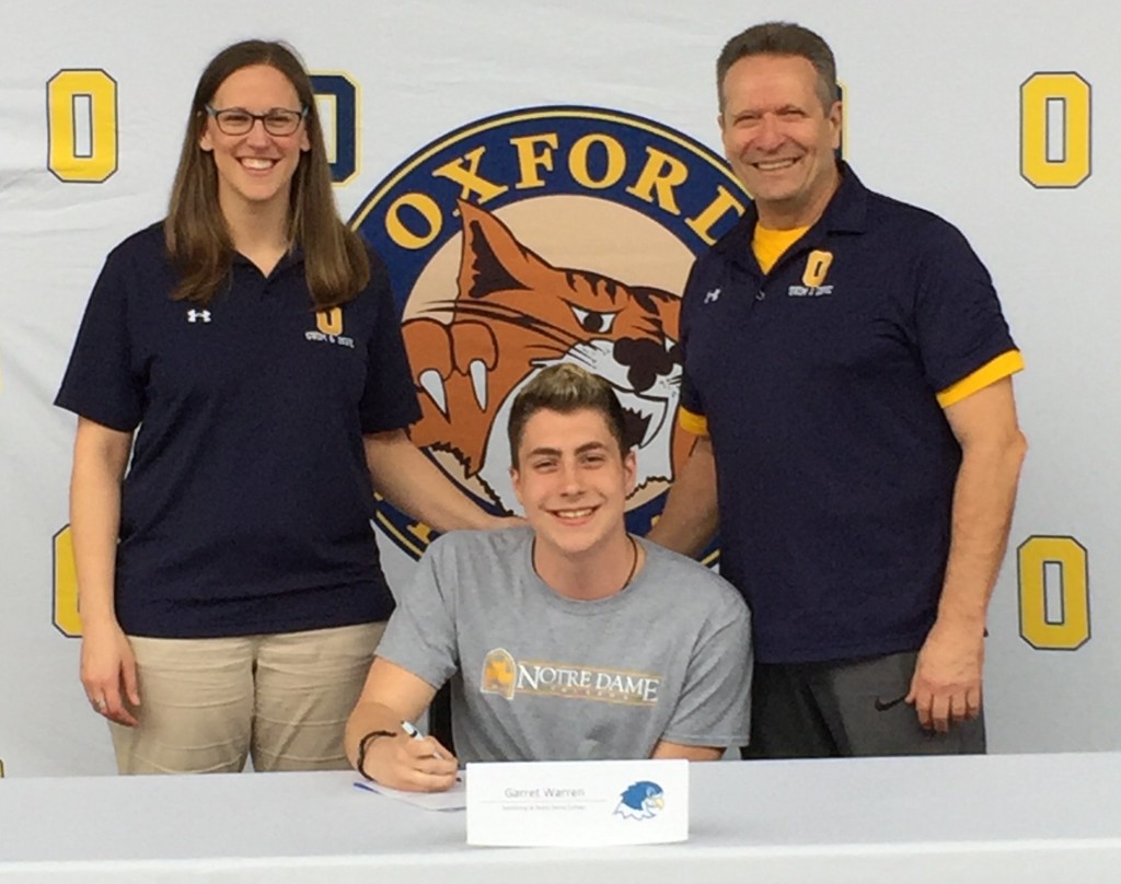 Wildcat swimmer Garrett Warren (center) received a scholarship to swim at Notre Dame College next year with Head Coach Jackie Rank (left) and Assistant Coach Paul Howard (right) standing by. Photo by Heather Smith.