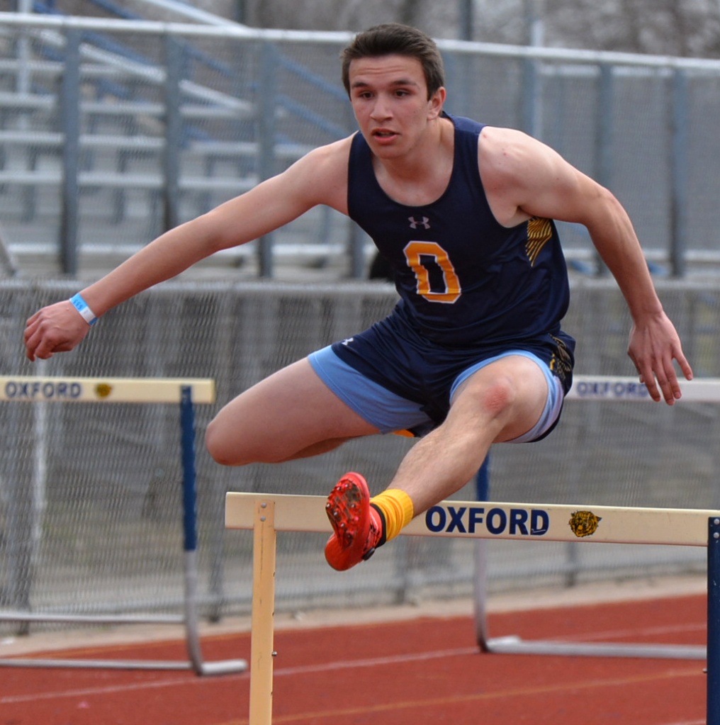 Oxford’s Shane Ross leaps over a hurdle. Photo by C.J. Carnacchio.
