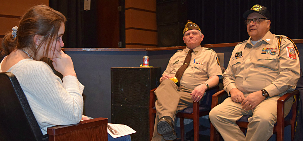 Greg Jones (left), an Air Force veteran and Jim Munoz, a Navy veteran, speak to Oxford High students. Listening is Syrena Coker. Photo by Elise Shire.