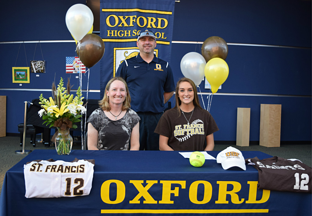 OHS senior Hannah Vachon (right) signed to play softball with the University of St. Francis in the fall. She poses with OHS Head Softball Coach Kenny Allen (center) and University of St. Francis Head Softball Coach Amanda Jensen. Photo by Elise Shire.